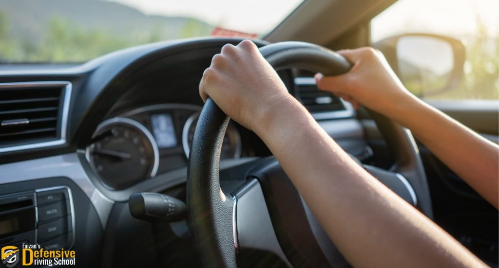 a driver holding wheel while driving